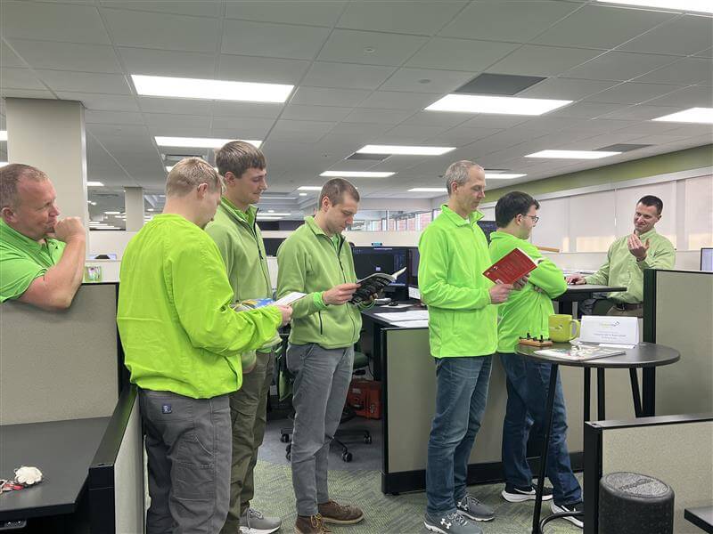 Civil engineering designers gathered in an office while waiting to discuss project details and ask questions during a collaborative workday.