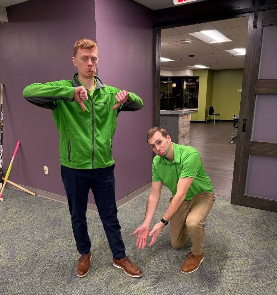 Choice One team members at a civil engineering, surveying, and landscape architecture firm humorously mourning a damaged shoe after an Office Olympics event.